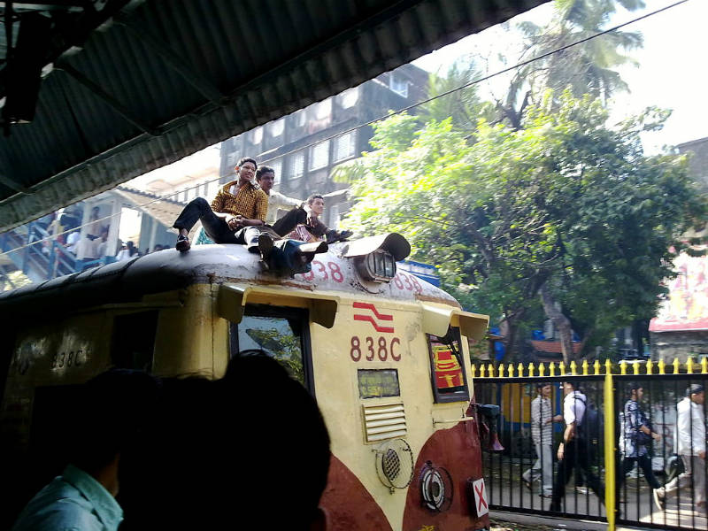 Passengers on the roof of a commuter EMU train in India